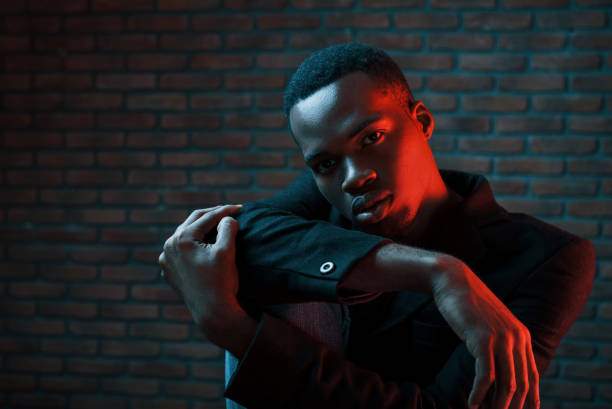istock Futuristic neon lighting. Young african american man in the studio 1186894927