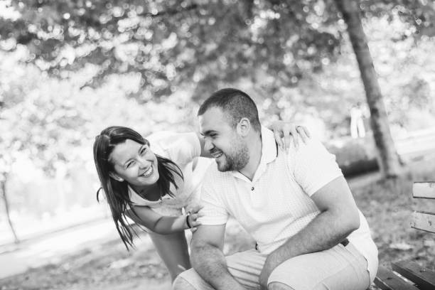 istock Smiling young couple in a park 1186898053