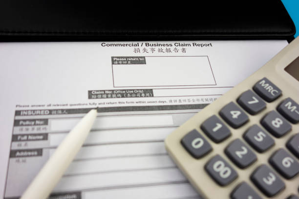 istock Insurance claimforms and calculators and pens as well as pens 1186899383