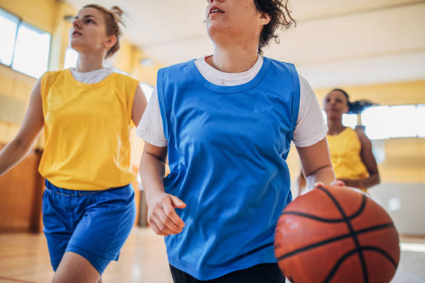 istock Women playing basketball indoors 1186899574