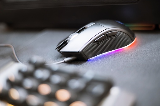 Close up of Computer RGB gaming mouse, Illuminated by colored LED