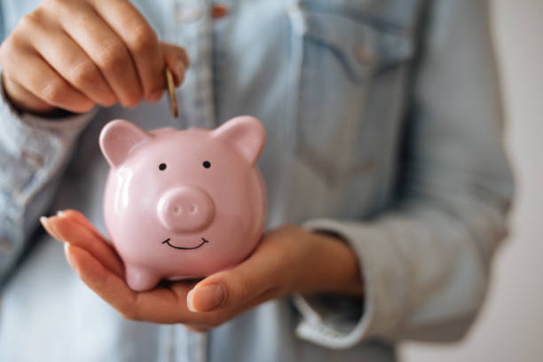 istock Saving money with piggy bank 1186901888
