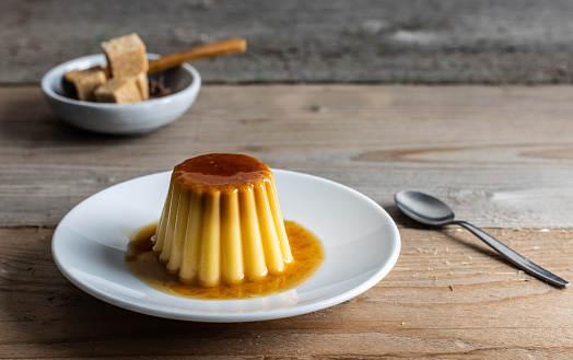 Homemade desert creme caramel pudding with a cup of coffee