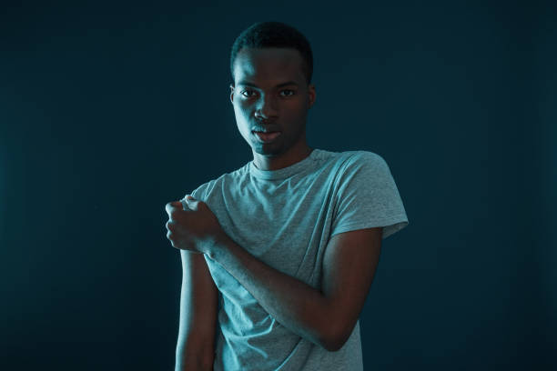 istock Futuristic neon lighting. Young african american man in the studio 1186902086