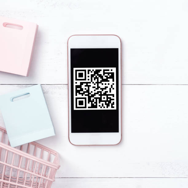 istock Abstract online shopping, mobile payment with QR code design concept element, colorful cart, paper bag on wooden table background. 1186907695