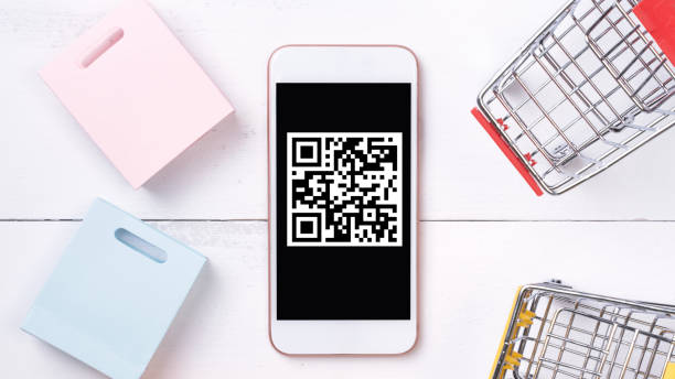istock Abstract online shopping, mobile payment with QR code design concept element, colorful cart, paper bag on wooden table background. 1186907721