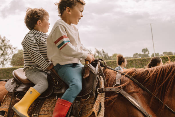 istock Brothers riding an horse 1186907724