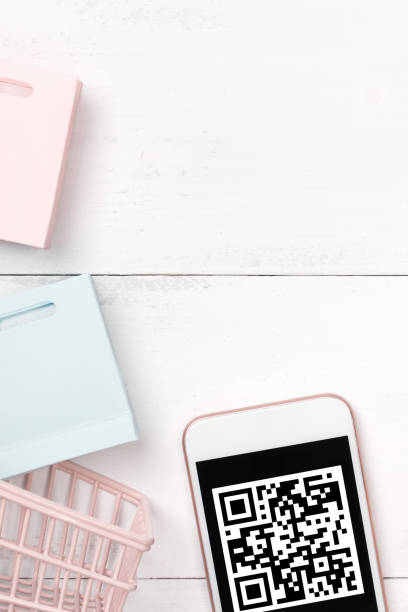 istock Abstract online shopping, mobile payment with QR code design concept element, colorful cart, paper bag on wooden table background. 1186907729