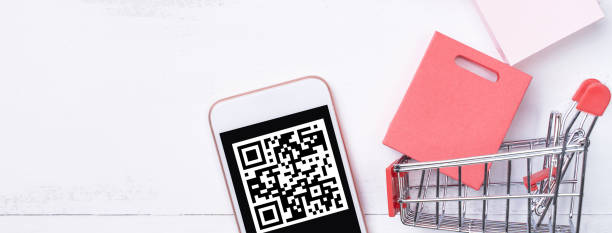 istock Abstract online shopping, mobile payment with QR code design concept element, colorful cart, paper bag on wooden table background. 1186907767
