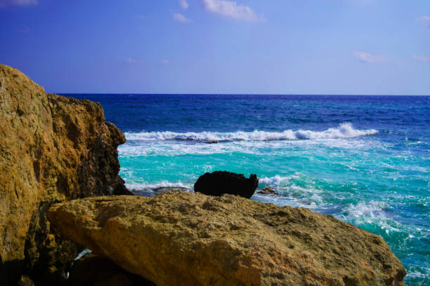 Sea waves crash and splash on rocks. Seascape of Greece.