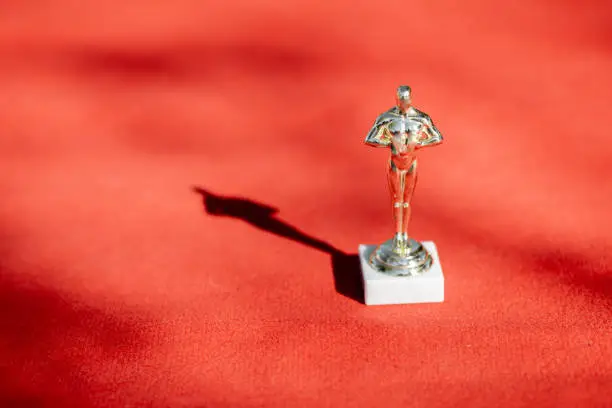 Famous film award statue on the red carpet outdoors, close-up