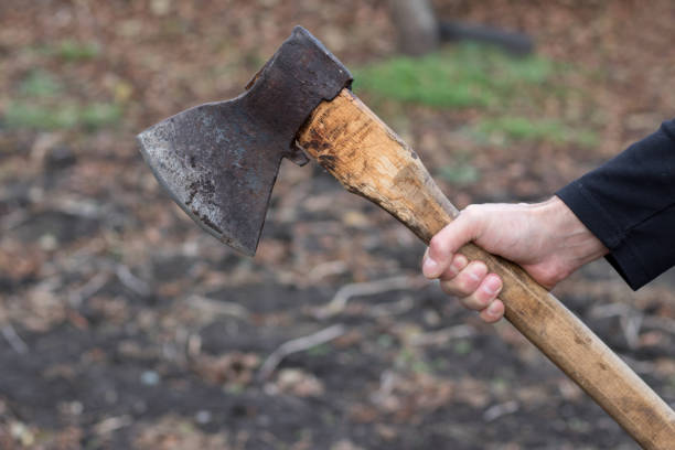 istock A man holds an ax in his hands against on black background 1186908945