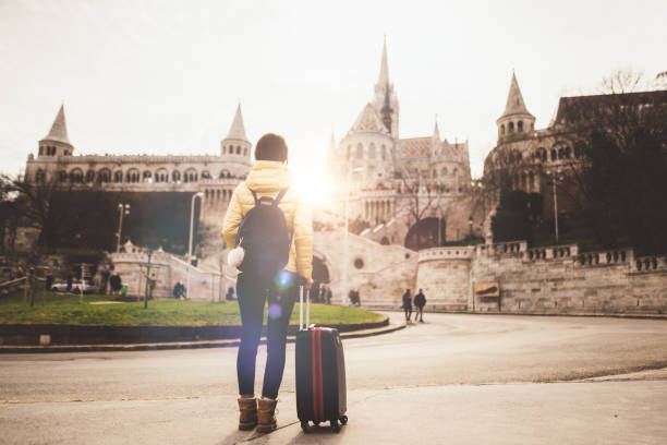 Tourist woman traveling solo in Europe Young woman with suitcase in Budapest fishermens bastion photos stock pictures, royalty-free photos & images