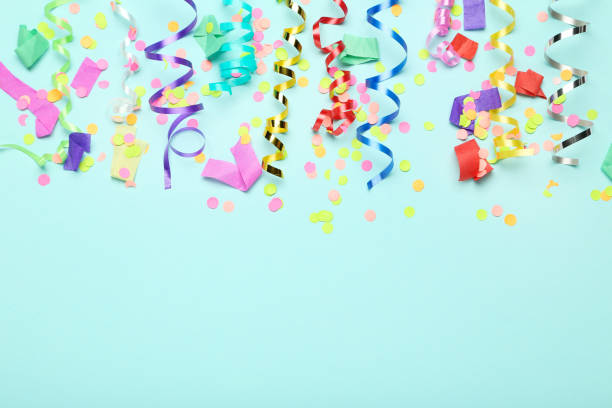 istock Colorful ribbons with confetti on blue background 1186909553