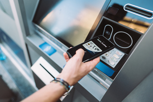 Man withdrawing money from ATM contactless