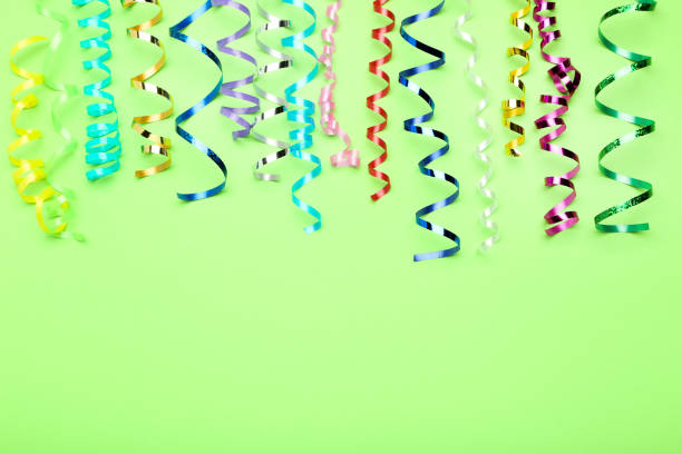 istock Colorful ribbons on green background 1186909778