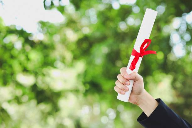 istock image of hand with degree certificate 1186913438