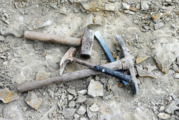 Fossil seeking with old utensils like hammer.