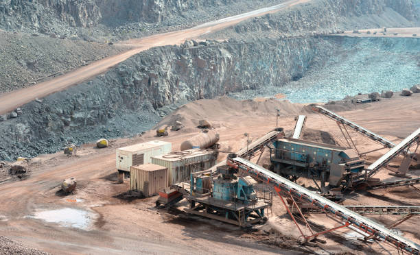 istock conveyor belt and stone crush in mining industry. 1186913702