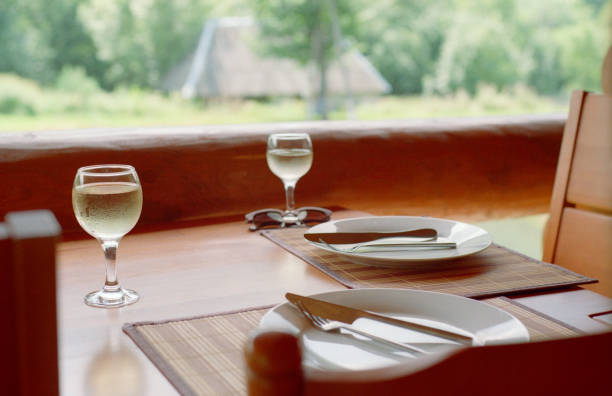 istock Wood table with service and wineglasses 1186913766