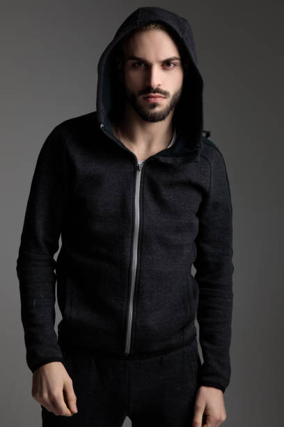 istock casual man staring at camera with his hood on head 1186914522