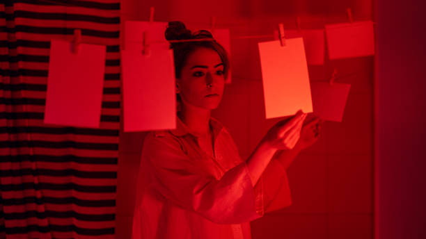 istock Girl developing photos in darkroom 1186914553