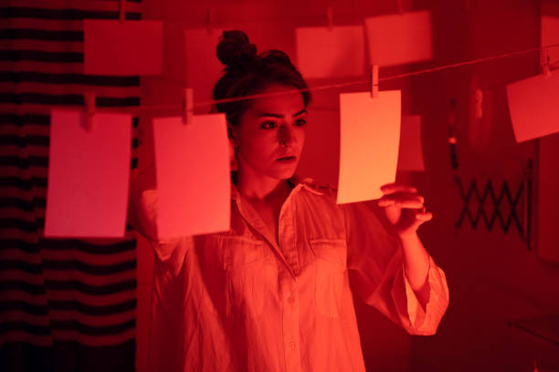 istock Girl developing photos in darkroom 1186914554