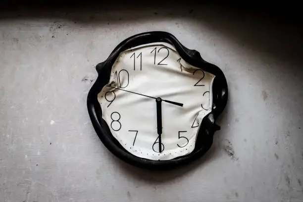 Photo of wall clock burned and melted by fire in a burnt kitchen