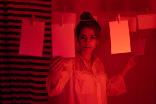 Girl developing photos in darkroom