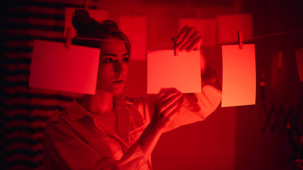 istock Girl developing photos in darkroom 1186914608