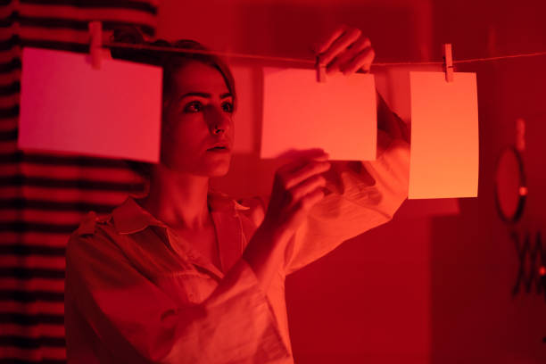 istock Girl developing photos in darkroom 1186914612