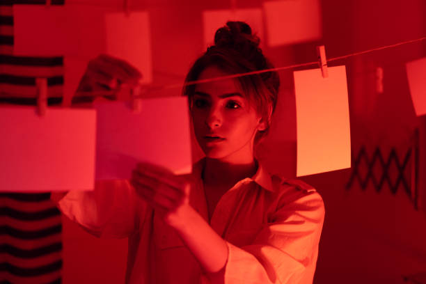 istock Girl developing photos in darkroom 1186914685