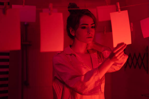 istock Girl developing photos in darkroom 1186914686