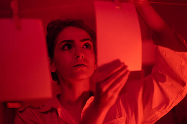 istock Girl developing photos in darkroom 1186914712
