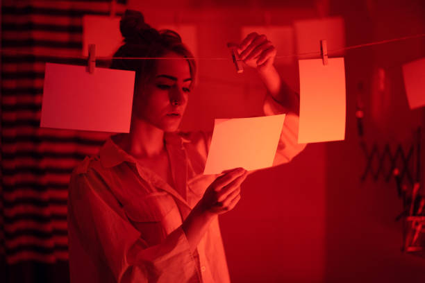istock Girl developing photos in darkroom 1186914716