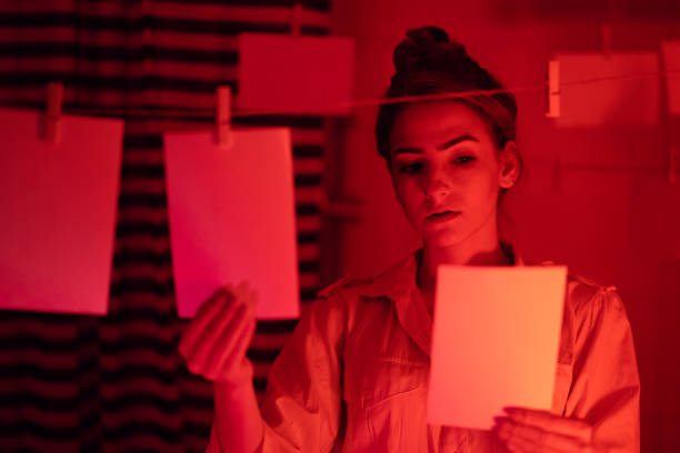 istock Girl developing photos in darkroom 1186914729