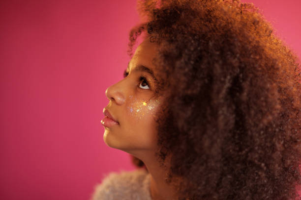 istock Cute girl with shiny makeup against pink background 1186914802