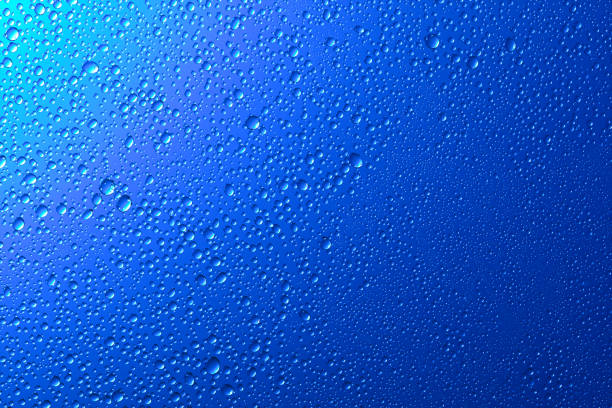 istock Blue glass surface with clear water drops, background 1186914811