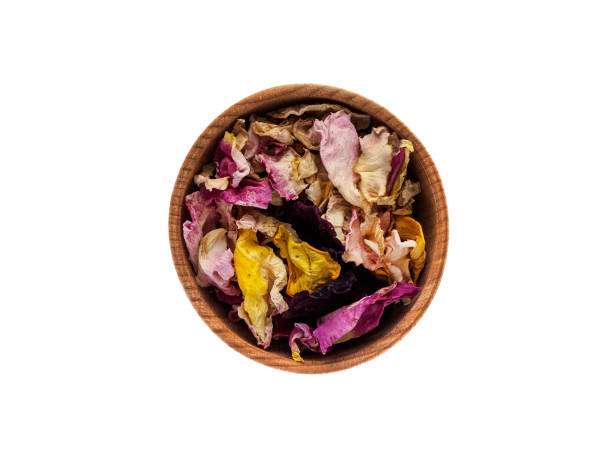 dried rose petals in a wooden cup on a white background - antioxidant medicine closed close to imagens e fotografias de stock