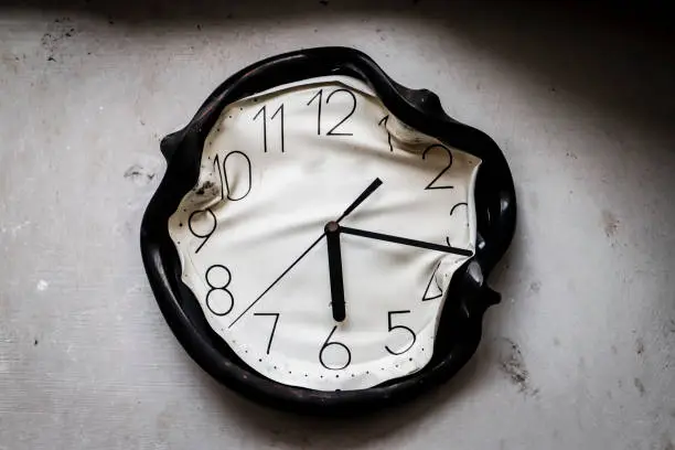 Photo of wall clock burned and melted by fire in a burnt kitchen