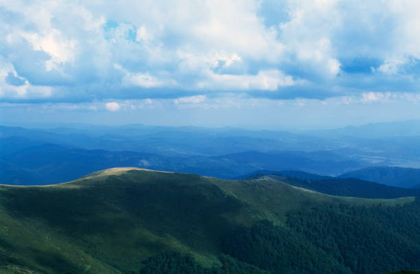 istock Mountain range landscape with couds and sunbeam 1186918235