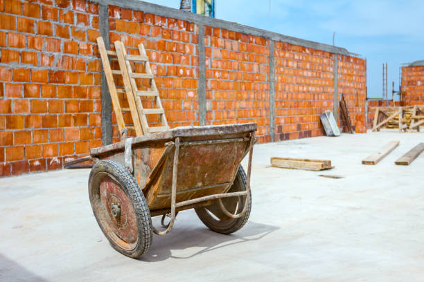Industrial obsolete wheelbarrow is used for transportation burden at construction site.