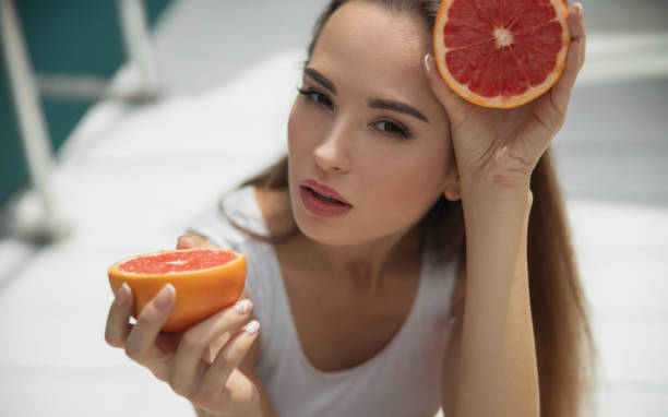 istock Beautiful lady in white swimsuit looking at camera 1186920189