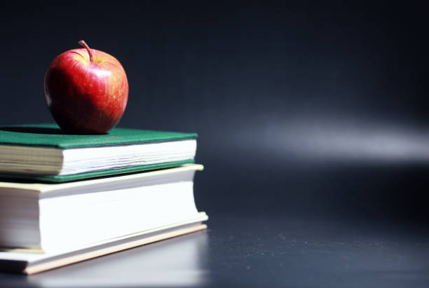 A stack of textbooks and books on table. The concept of knowledge and education.