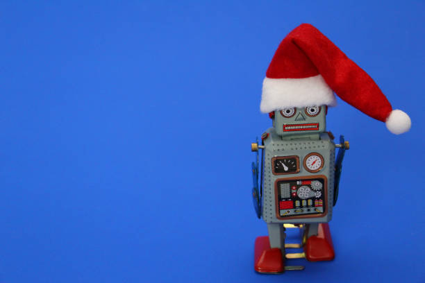 istock Retro robot on a blue background. The robot has a Santa hat. 1186923902
