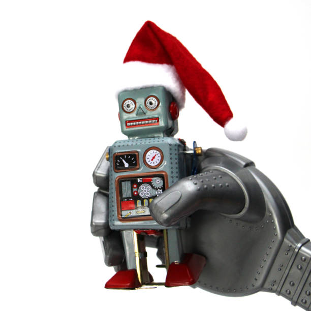 istock The robot holds a small retro robot in his hand. 1186924526