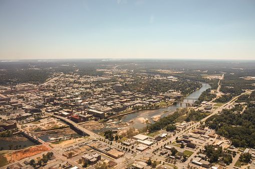 The Chattahoochee River separates Columbus, Georgia from Phenix City, Alabama (foreground), as shown from an aircraft on final approach to Columbus's airport.