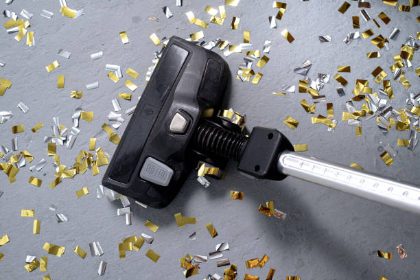Vacuum cleaner removes confetti. The party is over Vacuum cleaner cleans up bright confetti. the party is over. House cleaning. close-up. top view. 8571 stock pictures, royalty-free photos & images