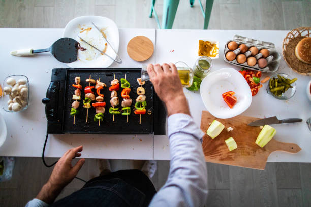 istock Skewers with chicken meat and vegetables on electrical barbecue 1186928081