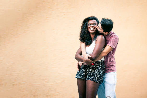 istock White guy embracing his black girlfriend 1186928316